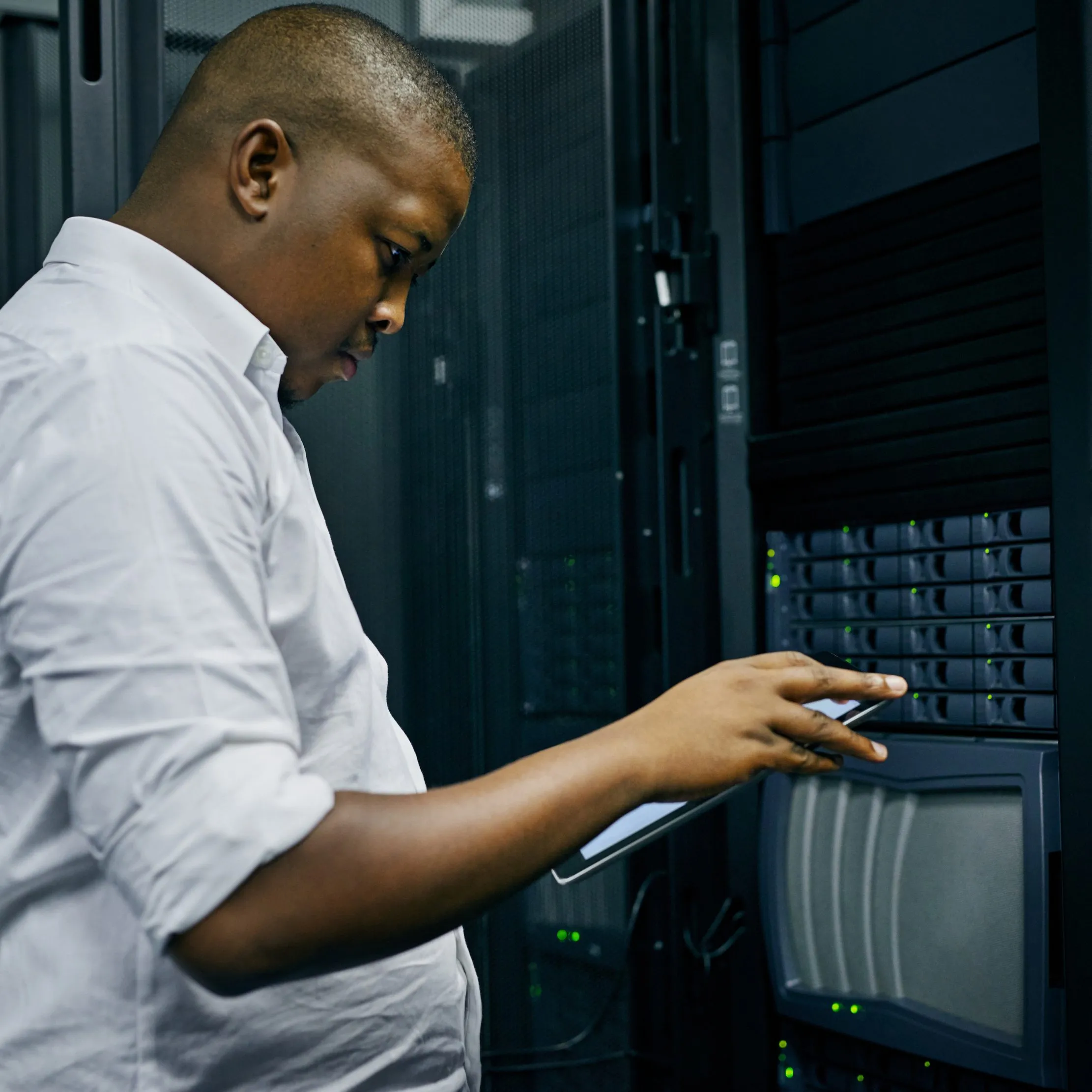 African technician reviewing server infrastructure on a tablet, representing a controlled administrator handover