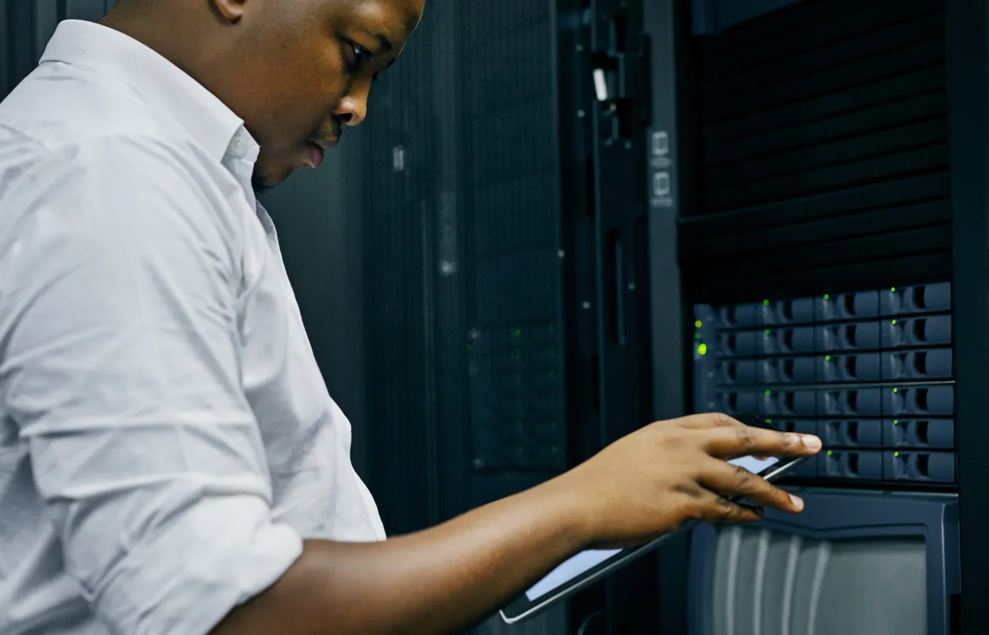 Administrator operating rack-mounted hardware with a tablet during a Windows admin handover