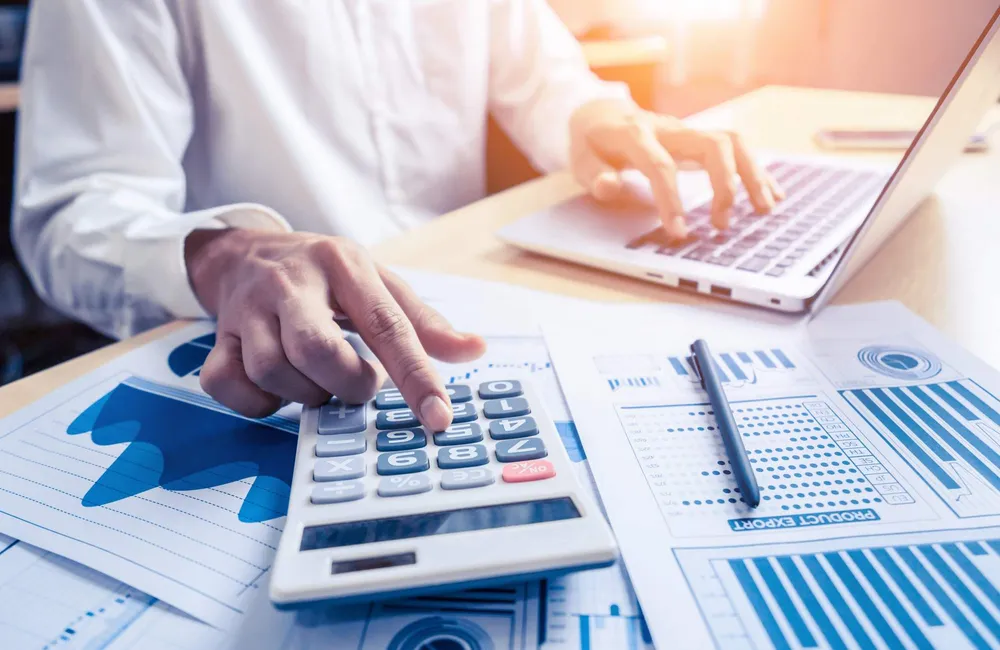 Calculator and financial charts representing accounting and finance controls