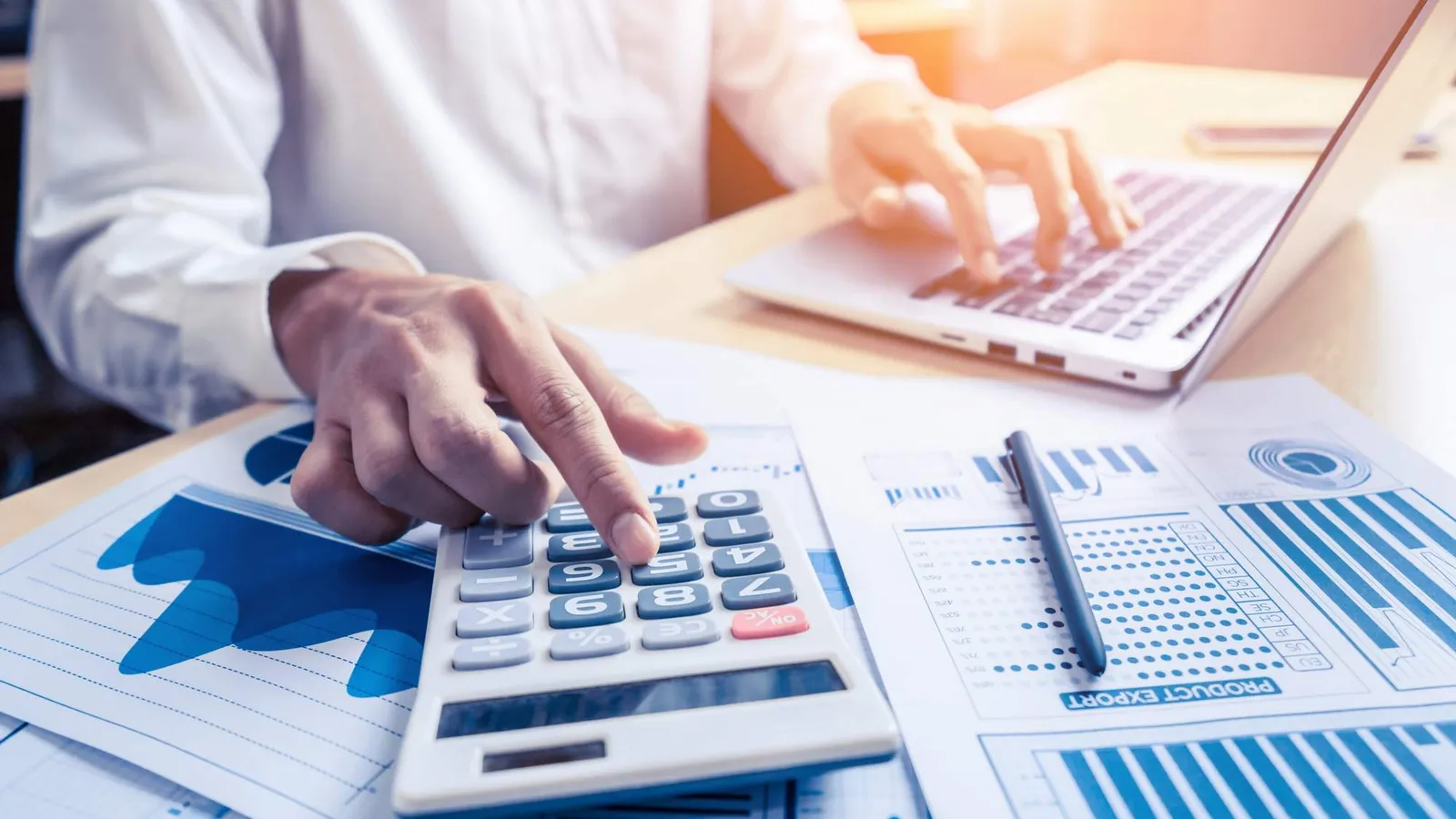 Calculator and financial charts representing accounting and finance controls