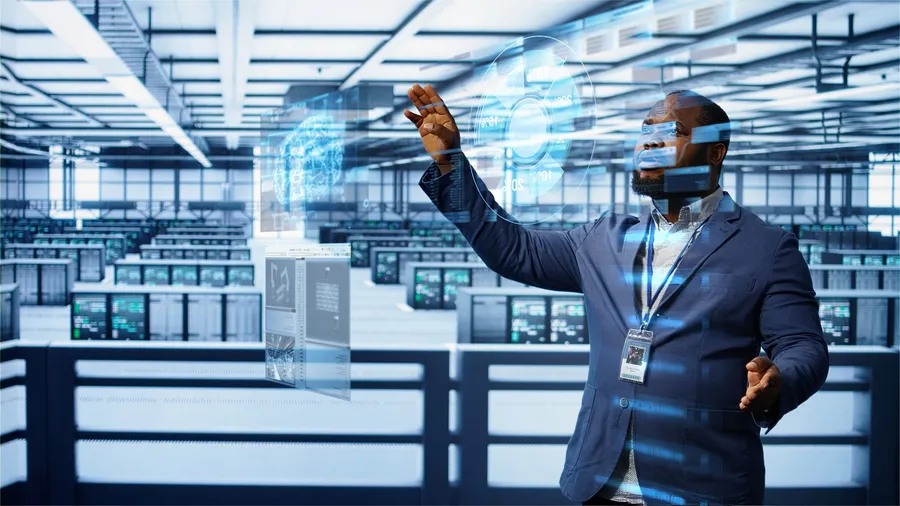 IT expert in a server room reviewing performance benchmarks on an augmented-reality hologram — infrastructure constraints in emerging-market AI adoption