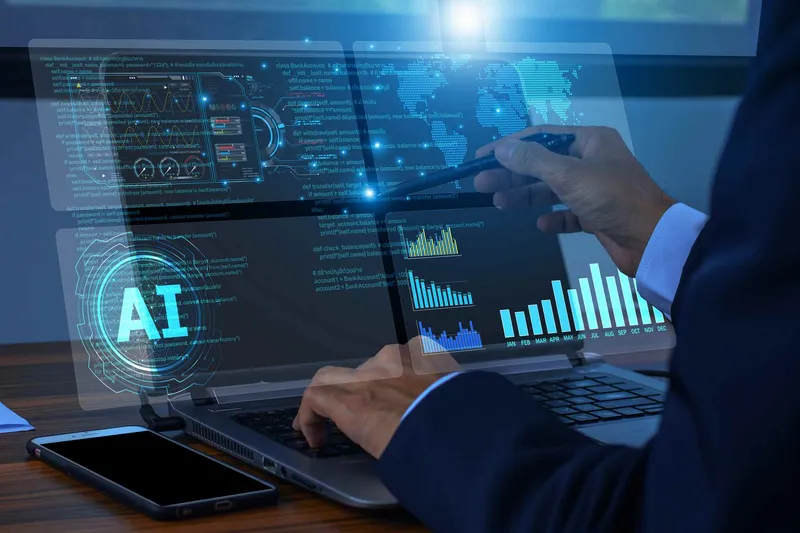 Business professional reviewing AI analytics dashboards on laptop and phone