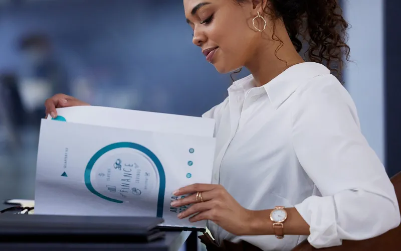 Finance professional reviewing a business document, representing an evidence-led AI-assisted business plan