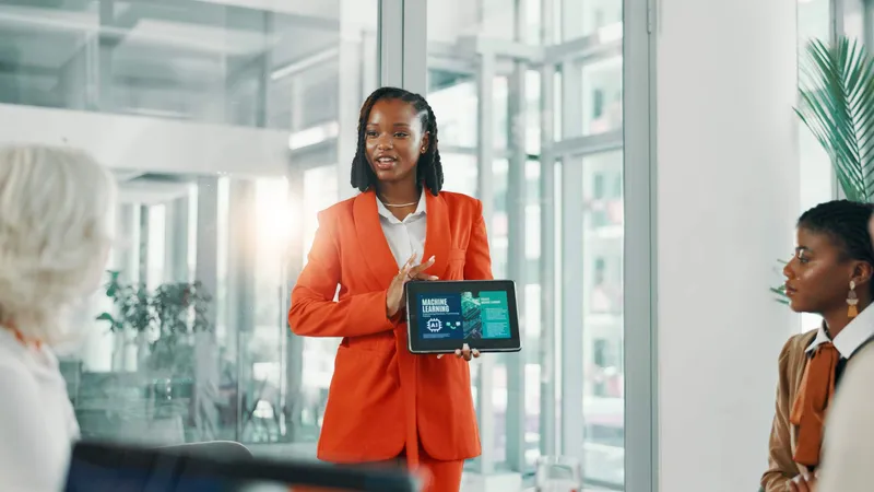 African business team in a boardroom collaborating with AI tools and dashboards