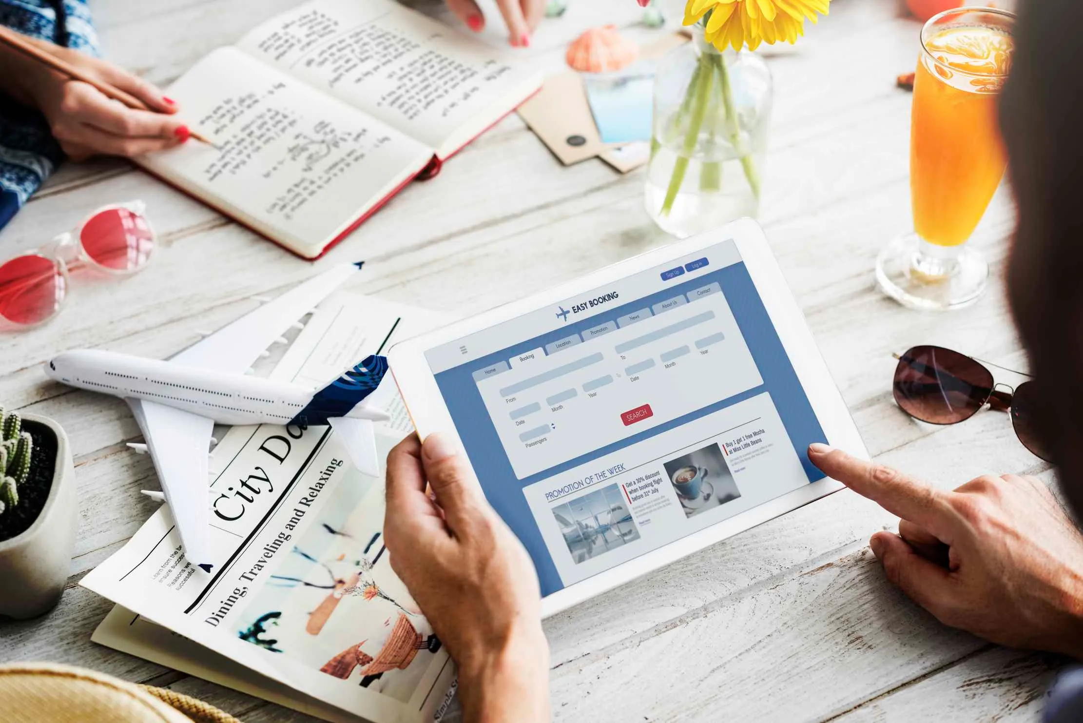 Business professionals evaluating website cost in Uganda by browsing a site on a tablet