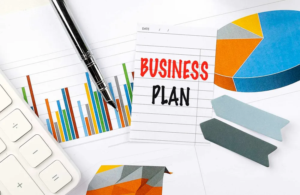 Business plan, charts, and calculator representing decision-ready planning