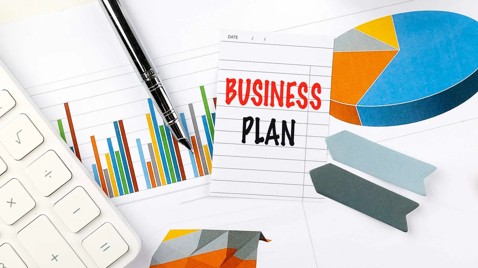 Business plan, charts, and calculator representing decision-ready planning