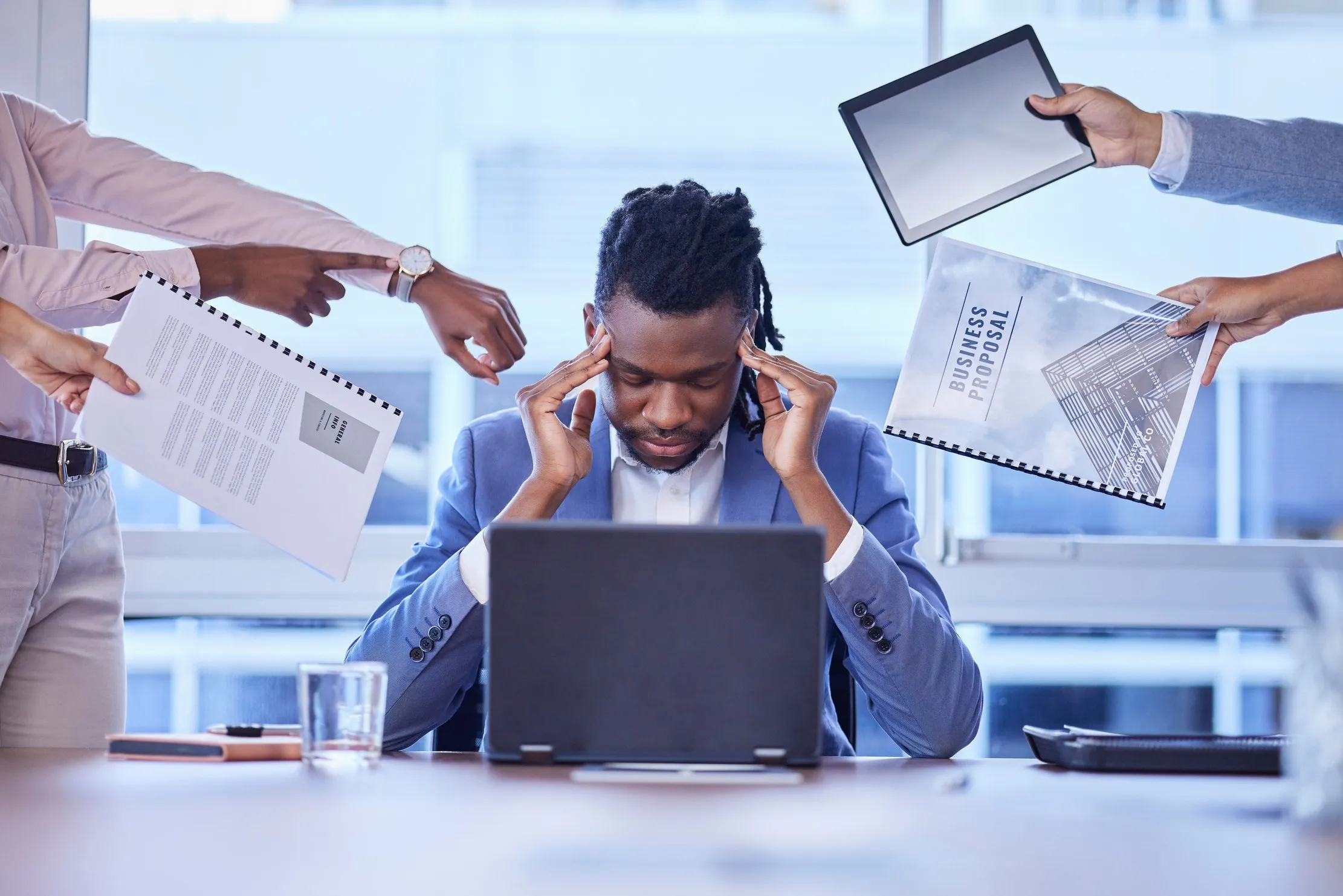 Overwhelmed manager surrounded by deadlines and reports — what a rushed cloud ERP migration looks like when the boring steps are skipped