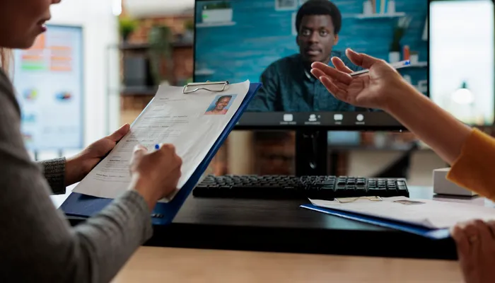 Technology leaders discussing a business decision around a large display in a collaborative office