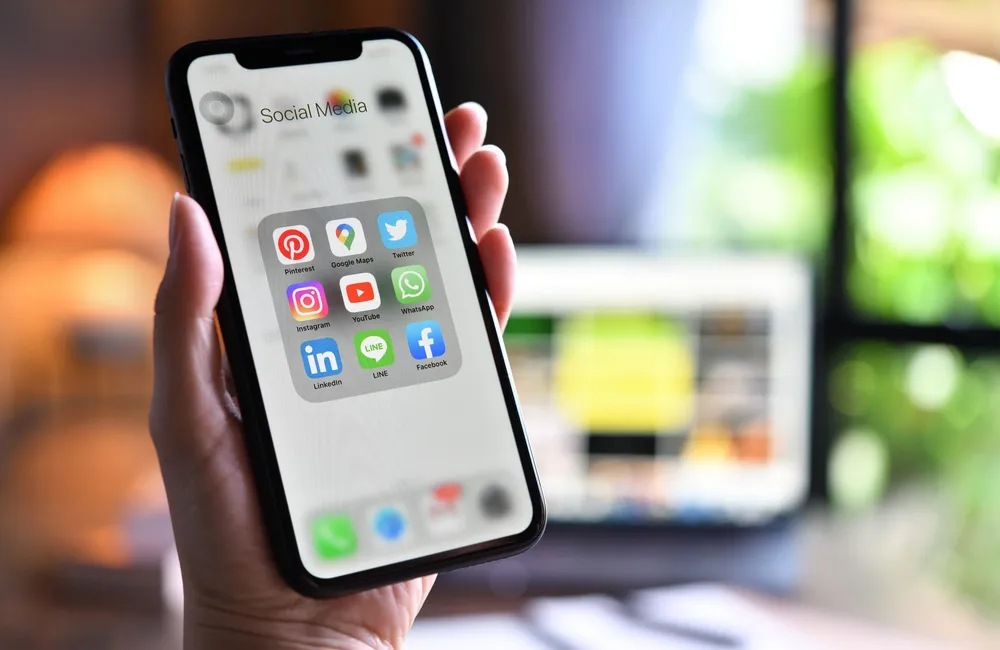 Smartphone showing social media channels for digital marketing planning