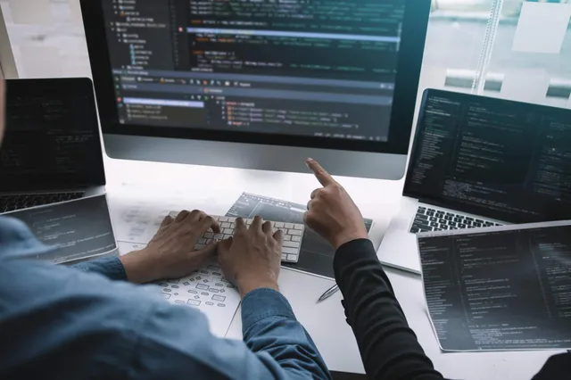 Software development workspace with code on screen