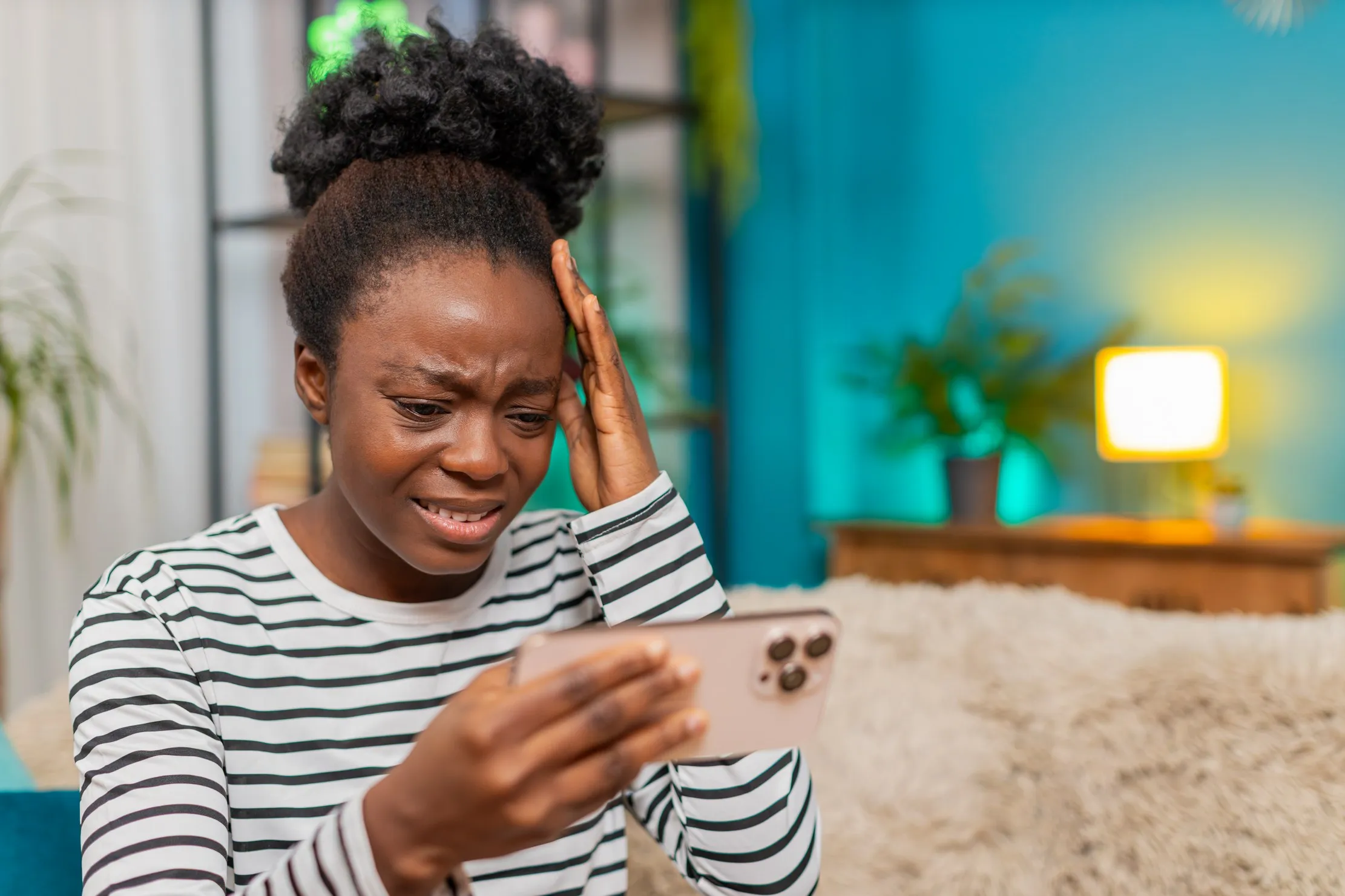 Woman checking a smartphone after an interrupted digital task